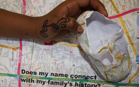 A participant from Shacklewell school holds their work - Mapping Culture