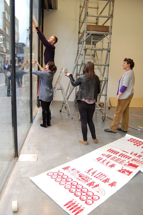 Putting up the Vinyl artwork - iniva at Rivington Place